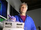Halloran, in studio with slab of ice painting